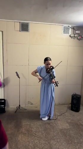 Musician performs violin as Kazan captures evening cityscape moments