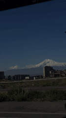 Snow-covered Mount Ararat visible from vehicle in Yerevan