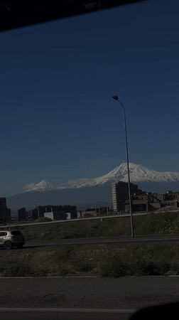 Snow-covered Mount Ararat visible from vehicle in Yerevan