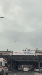Group waves from overpass during rainy day in Serbia