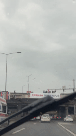 Group waves from overpass during rainy day in Serbia