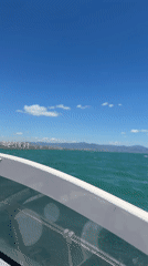 Boat passenger records sunny day on turquoise waters near Torremolinos
