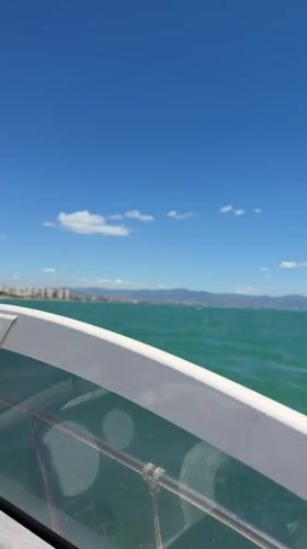 Boat passenger records sunny day on turquoise waters near Torremolinos