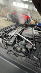 BMW vehicles serviced at automotive facility, exhaust smoke observed