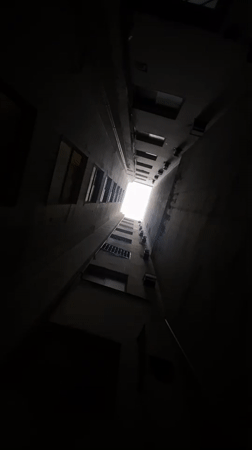Upward view captured through narrow Buenos Aires courtyard passage