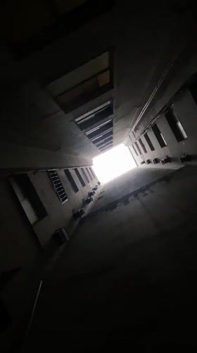 Upward view captured through narrow Buenos Aires courtyard passage