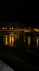 Night cycling along Trento's Adige River, Chiesa di San Vigilio glowing overhead