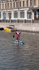Paddleboards fill a Saint Petersburg canal on a summer morning