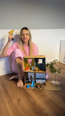 Woman creates miniature house diorama with craft supplies in Latvia