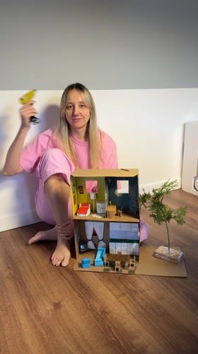 Woman creates miniature house diorama with craft supplies in Latvia
