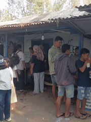 Dragon kites and crowds fill an Indonesian beach festival