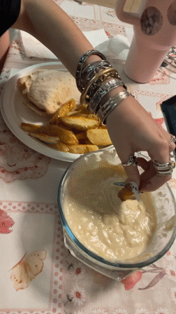 Casual meal of potato wedges and pita documented in Raanana