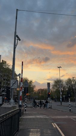 Evening dusk scenes captured across Amsterdam streets and canals