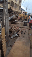 Partial building collapse site in Egbagu with heavy machinery on scene