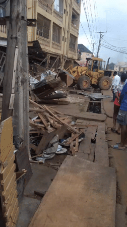 Partial building collapse site in Egbagu with heavy machinery on scene
