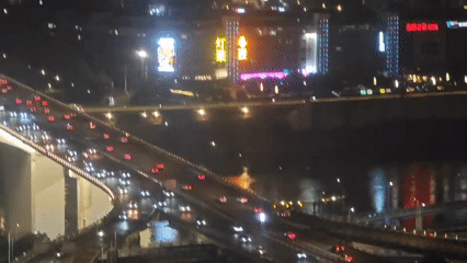 Evening traffic flows on elevated highway in Yuzhong District