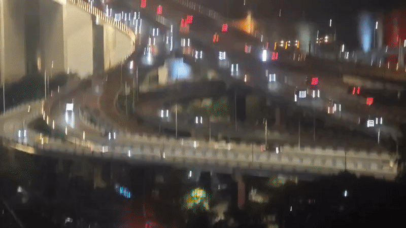 Evening traffic flows on elevated highway in Yuzhong District