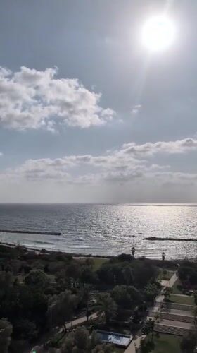 Tel Aviv coastline and cityscape from a sunny rooftop vantage