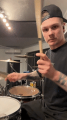 Tattooed man juggles drumsticks in Russian village