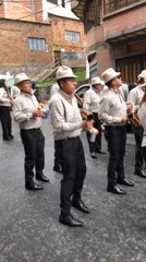 Costumed performers parade through La Paz streets in evening celebration