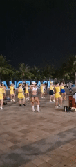 Women perform coordinated dance in Đà Nẵng park at night