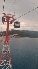 Tourists ride cable cars over water in Nha Trang
