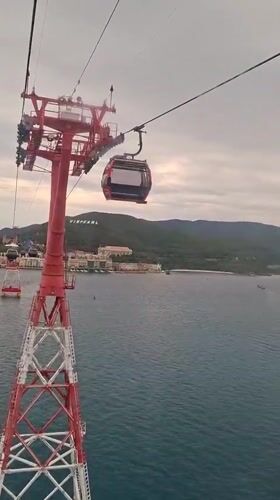 Tourists ride cable cars over water in Nha Trang