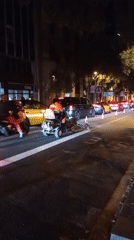 Road maintenance worker operates equipment on Barcelona street Thursday night