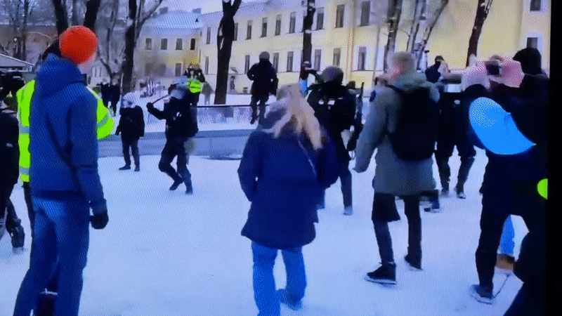 Winter-dressed group gathers in snowy Beryozovka public space
