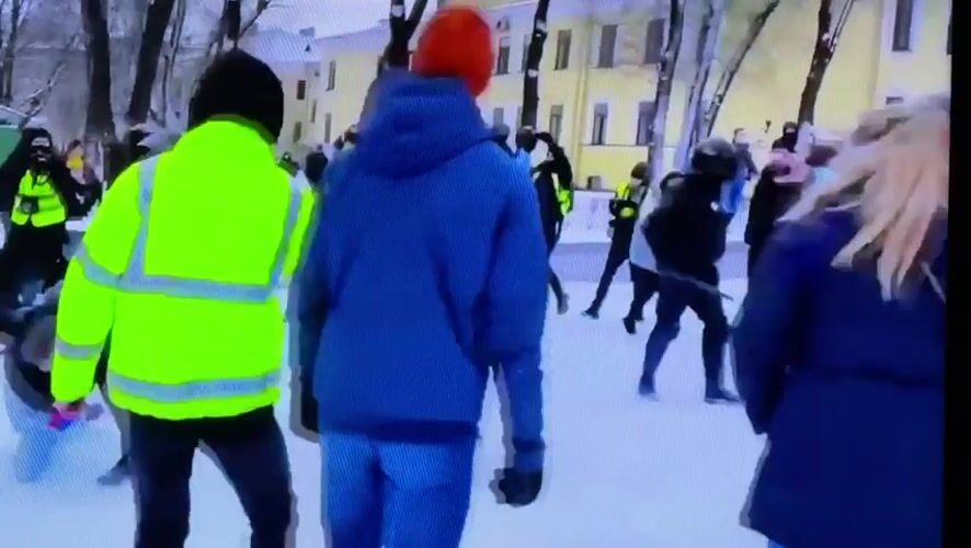 Winter-dressed group gathers in snowy Beryozovka public space