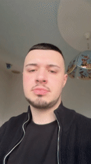 Man makes playful gestures for camera in Smolyan, Bulgaria