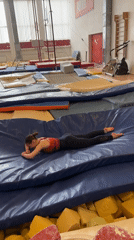 Gymnast falls onto mat during training session