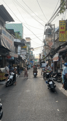 Typical motorcycle traffic observed on narrow street in Thủ Đức