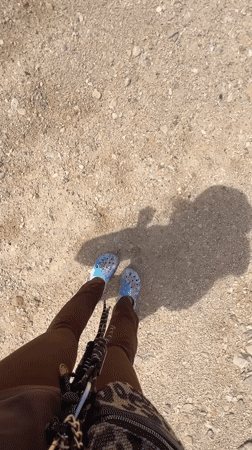 Person walks through arid Israeli desert near NEVO building
