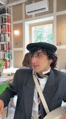 Person in beret photographed multiple times at Moscow cafe