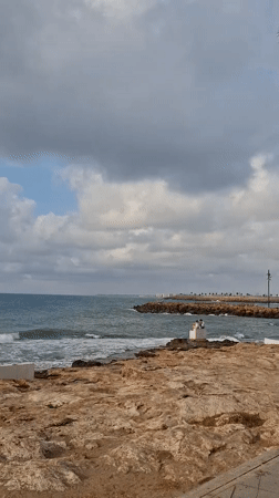 Torrevieja's rocky coastline and promenade on a cloudy morning