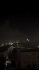 Smoke and city lights over Kyiv at night