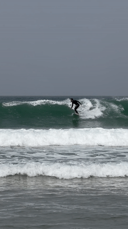 Surfer wipes out on overcast morning at Tel Aviv beach