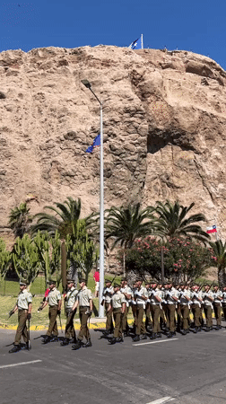 Military parade with armed soldiers marches through Arica, Chile
