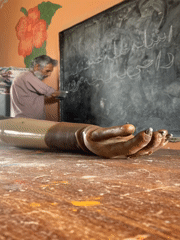 Elderly amputee teacher conducts lesson in Pakistani classroom