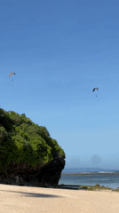 Beach scenes with paragliders, swimmers documented during morning hours