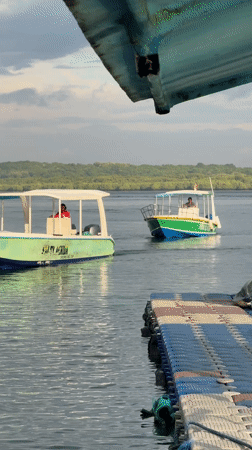 Boats navigate clear waters near Nusa Penida coastline