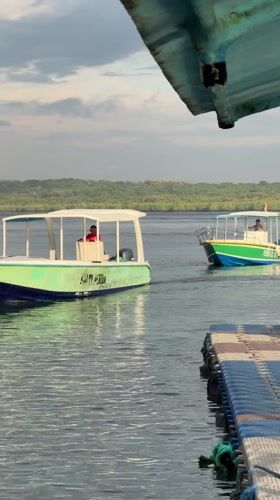 Boats navigate clear waters near Nusa Penida coastline