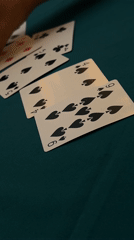 Card game in progress on green felt in Puebla