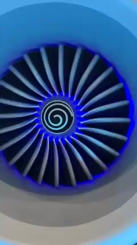 A close-up shot shows an engine fan with blue lighting. The fan has numerous blades and a spiral design in the center. The image is stable and focused on the central fan. The outer casing of the engine is partially visible.