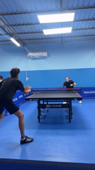 Table tennis in a vivid blue indoor court, Wichit