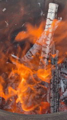 Person chops wood, tends fire in Russian village