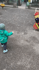 Child in dinosaur jacket plays in Moscow park