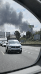 Highway traffic captured in car mirror in Mollet del Vallès