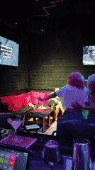 Group enjoys karaoke session with costumes and dancing